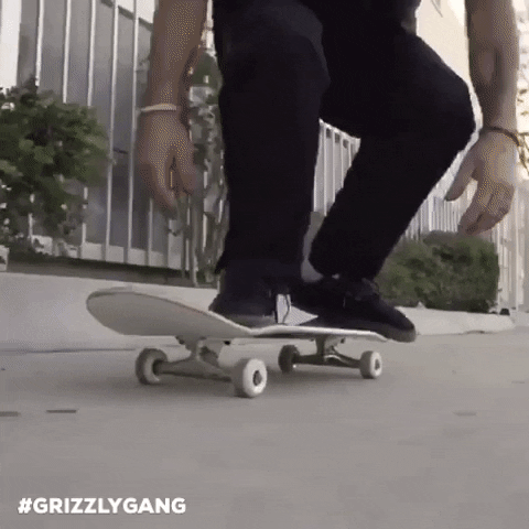 A person doing a tre flip on a skateboard.